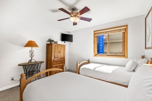 Snow Flower Condominium 14s additional bedroom with 2 twin beds and flat screen TV.