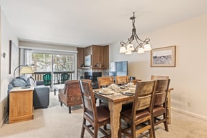 Snow Flower Condominium 147s table for 6 next to open living room.