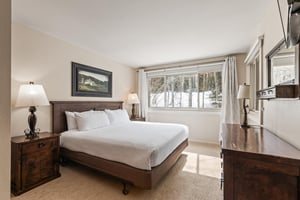 Snow Flower Condominium main suite with king size bed.