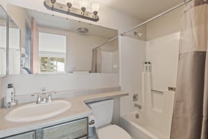 Snow Flower Condominium 147s guest bathroom with showertub.