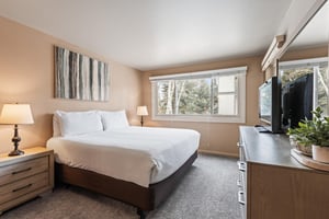 Premier Snow Flower Condominium 107s main suite with king bed and dresser.