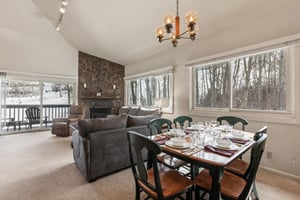 Premier Snow Flower Condominium 130s dining room for 6, and open concept living room.