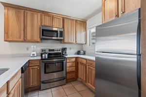 Premier Snow Flower Condominium 130s open concept kitchen with stainless steel appliances.