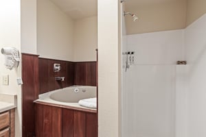 Snow Flower Condominium 147s main suite bathroom that features a jetted tub as well as a separate shower.