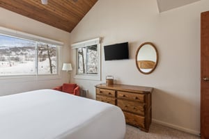 Premier Snow Flower Condominium 130s main suite flat screen TV and dresser.