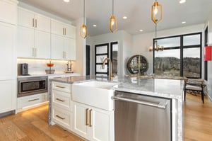 Cook your favorite meals in this kitchen with granite counters, pendant lighting, and  views.