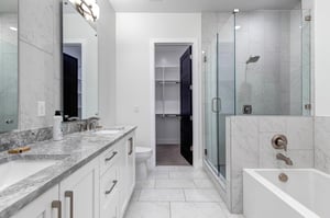 The en suite bathroom features a spacious walkin shower, elegant soaking tub, and premium finishes.