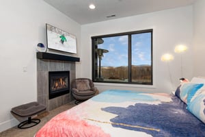 Cozy up by your crackling fireplace while soaking in mountain views from the second bedroom.