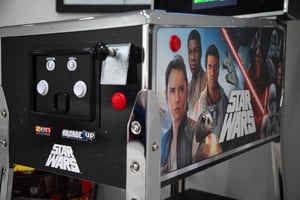 Challenge friends to epic battles with this vintage Star Wars pinball machine in the game room.