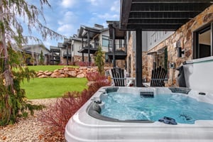 Unwind in your private hot tub while enjoying peaceful views and modern comfort.