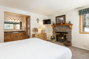 Enjoy a warming fireplace at the foot of your bed