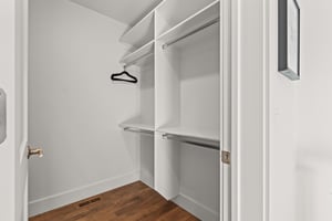 Your spacious walkin closet offers organized storage with dual hanging rods and shelving.