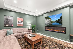Sink into plush sectional seating next to a builtin fireplace for movie nights on the large wallmounted TV.