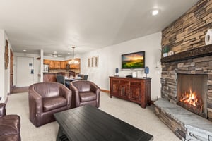 A spacious living room with comfortable leather seating and wallmounted TV.