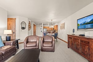 Unwind in your spacious living room with leather club chairs and a big screen TV.