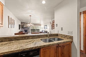 Prepare meals effortlessly in in the kitchen, overlooking the cozy living and dining areas.