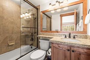 The en suite bathroom with bathtub and shower combination.