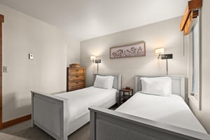 Rest peacefully in your twin bedroom with crisp white linens and wood furniture.
