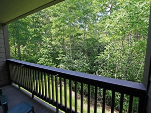 Enjoy the private patio with forest views in the summer at the Snow Flower 149 vacation rental.