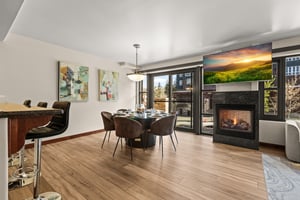 At your private vacation rental, Lowell 203, you can gather around an elegant dining table with cozy fireplace.