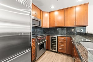 A gourmet kitchen awaits with granite counters, cherry cabinets, and premium stainless steel appliances.