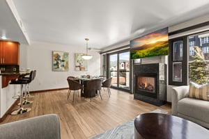 A private vacation rental with a spacious living area featuring a cozy gas burning fire and a flat screen TV above.