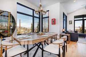 The wood dining table with seating for six guests.