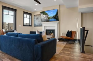 The living room with statement art on the wall, gas fireplace, and warm lighting.
