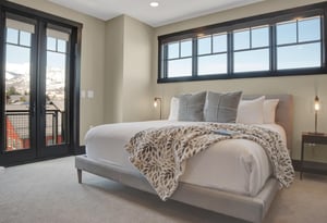 The main suite with a king size bed with large window above.