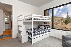 The cozy bunk room offers a queen bunk beds and a trundle bed.