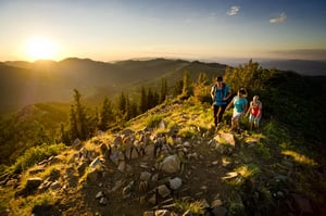 A group of hikers on the ridge tops overlooking the Wasatch mountain range.