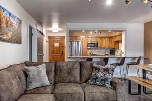 Resort Plaza 5024 offers an open concept living area with brown suede sectional sofa.