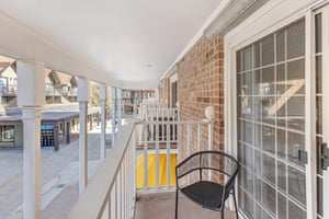 Enjoy your own private covered patio with white picket fencing overlooking the plaza.