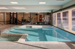 The Resort Plaza inside pool and hot tub with the weight room behind it.
