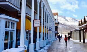 View of shops in Resort Plaza and large white architectural pillars lining the building.