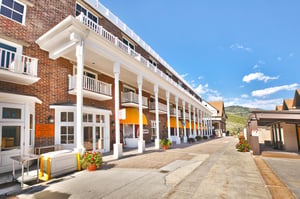 Resort Plaza north entrance lined with shops and views of the mountains.