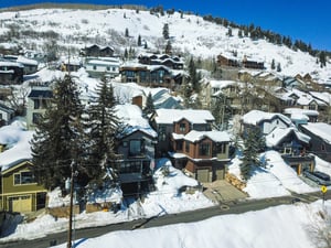 A snowy mountain and neighborhood situated behind 159 Woodside vacation rental.