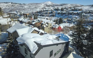159 Woodside is surrounded by snowy homes and mountains.