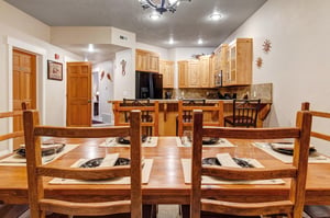 Gather around the warm, rustic dining table where memories are made over hearty meals and good company in your mountain retreat.