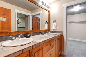 Youll love this bright, airy bathroom with double vanities, warm wood accents, and soft towels waiting for you—perfect for refreshing after a day of adventure.