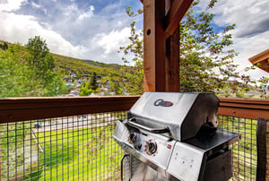 This gas grill on your private balcony invites you to savor meals outdoors while soaking in peaceful mountain and neighborhood views, perfect for grilling fresh dinners in the open air.