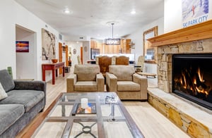 Unwind in your spacious living area with a gas burning fireplace and mountaininspired décor.