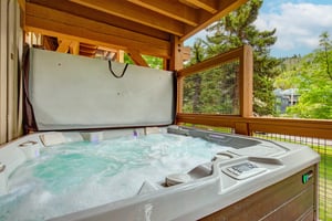 Slip into your private hot tub under a covered deck and let warm, bubbling water melt your cares away while you take in forest and mountain views.