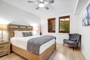 Sink into plush bedding and let the ceiling fans gentle breeze lull you to sleep. Natural light pours through charming woodframed windows, while your cozy reading chair awaits those lazy morning mom