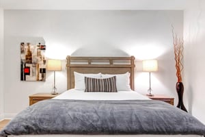 Sink into crisp white linens and plush textures in your serene bedroom retreat.