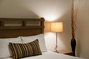 The queen bed in the second bedroom offers crisp linens and plush pillows.