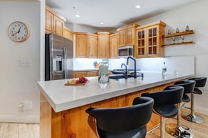 Gather around the spacious breakfast bar to prepare meals together.
