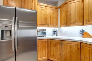 Your fullyequipped kitchen features stainless steel appliances and warm wood cabinetry.