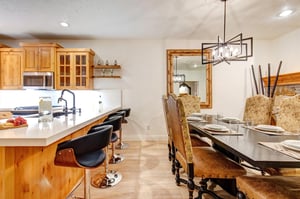 A breakfast bar with seating for 4 guests and a handsome dining table with seating for 6.