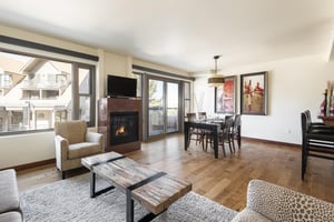 Granite surround fireplace separates living and dining area with large patio glass doors